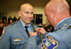 Captain Jeff Christopher receives his badge from Chief McCormick